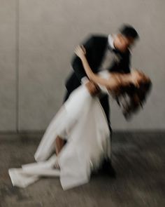 a man and woman are dancing on the floor