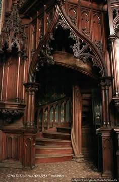 an ornate wooden building with stairs and railings