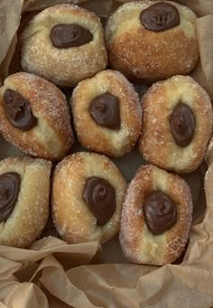 a box filled with lots of donuts covered in chocolate