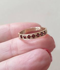 Solid gold Garnet half eternity ring, Garnet stacking ring, stacking gemstone rings, January birthstone ring, Garnet gold ring Solid gold, handmade half eternity stacking ring, stoned with 7 beautiful deep red gemstones. This multistone ring is beautiful alone or stacked together with other rings and is colorful and pretty on your finger. The ring is available in 9k or 14k solid gold- yellow, white or rose. It is also available in nickel free, 14 karat gold plating over brass or silver and in so 14k Gold Eternity Band With Gemstone As Gift, Heirloom Stackable Eternity Band As Gift, Dainty Stackable Ruby Ring For Anniversary, Half Eternity Stackable Rings As Gift, Stackable Half Eternity Rings As A Gift, Stackable Half Eternity Rings As Gift, Gift Stackable Half Eternity Rings, Red Engagement Ring, January Birthstone Rings