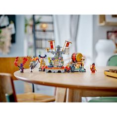 a wooden table topped with toy figurines on top of it