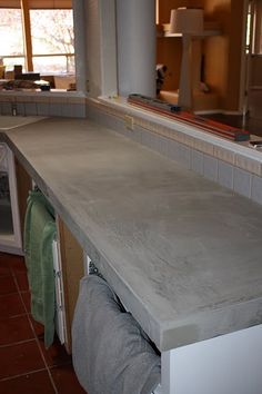 a kitchen counter that has some towels on it