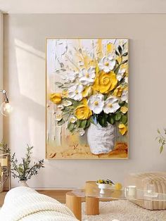 a white vase filled with yellow and white flowers