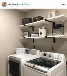 a white washer and dryer sitting next to each other in a laundry room