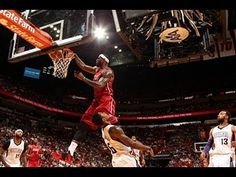 the basketball player is going to dunk the ball in the air during a game