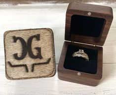 This listing includes (1) wooden ring box. You can purchase personalized or plain. We also offer this box with a cowhide brand/monogram OR engraved directly onto the wooden top... Please include your personalized details in the personalized details section. Box is 2X2X1.5 Inches Follow Us For More Offers: hppt://www.facebook.com/cutfromtheheart.net/ https://www.instagram.com/cutfromtheheart/ www.cutfromtheheart.net Questions? If you have any questions about this shirt, just use the message selle Country Engagement Rings, Western Engagement Rings, Western Wedding Rings, Engraved Ring Box, Western Rings, Engagement Ring Holders, Cowboy Wedding, Wooden Ring Box, Country Engagement