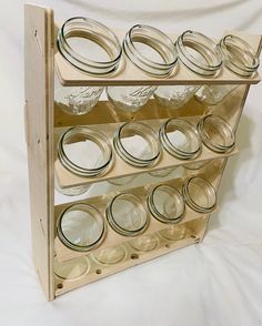 a wooden rack with mason jars on it