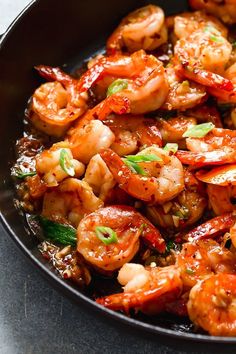 a skillet filled with shrimp and sauce