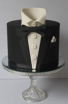 a black and white cake with a tuxedo on top