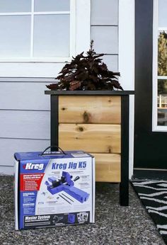 a box sitting on the ground next to a planter with a kreg jik in it