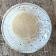 a blender filled with liquid sitting on top of a wooden table