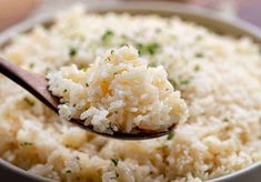 a spoon full of rice with parsley on top