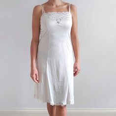 This is a neat, fitted vintage slip dress in off-white. It has spaghetti straps, chest lace details and a lace trimmed hemline. The slip is made from smooth, lightweight and silky to touch fabric. Perfect for wearing underneath the dress or as a nightie. Made by St. Michael in United Kingdom. 100% nylon/ poliamide mix. Labelled as size 14 UK long, 42 EUR, would fit Medium size. Measurements when laid flat are: Bust: 42cm Waist: 39cm Hips: 50cm Length: 103cm Excellent condition. B+E Dark Floral Dress, Vintage Slip Dress, Womens Lingerie, Vintage Slip, Vintage Slips, Midi Slip Dress, Lace Slip Dress, 80s Dress, Silk Slip Dress