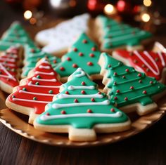 decorated christmas cookies on a plate with lights in the background