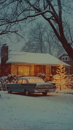 an old car parked in front of a house with christmas lights on the windows and trees