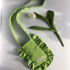 a green purse with a flower on it