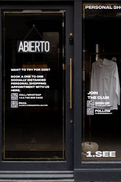 a store front window with an advertise for aberto written on it