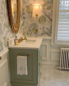 a bathroom with a sink, mirror and towel on the counter in front of a radiator