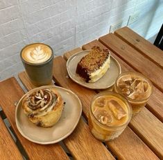 three desserts and two drinks are sitting on the table