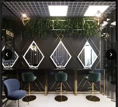 the interior of a salon with chairs and mirrors on the wall, along with plants