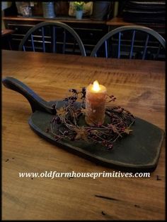 a candle sitting on top of a wooden tray