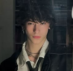 a young man wearing a black tie and white shirt