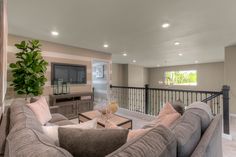 a living room filled with furniture and a flat screen tv on top of a wall