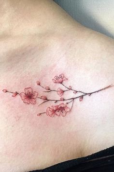 a woman's chest with pink flowers on it