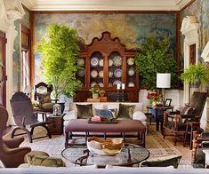 a living room filled with furniture and lots of plants