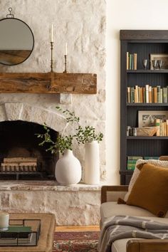 a living room with a fire place and bookshelf in it's corner