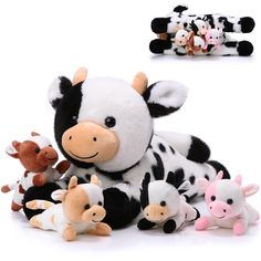 a cow stuffed animal surrounded by other farm animals, including two baby cows and three smaller ones