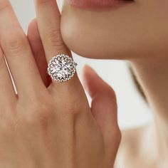 a woman's hand with a diamond ring on her finger