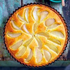 an orange pie sitting on top of a wooden table