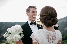 a bride and groom laughing at each other