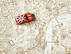 a toy car is sitting on top of a map with the british flag painted on it