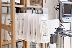 the medical equipment is on display in the glass case, with papers hanging from it's sides