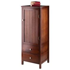 an armoire with books on top of it