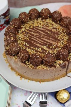 a chocolate cake on a white plate with silverware