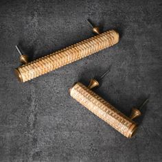 two wooden pegs sitting next to each other on top of a carpeted floor