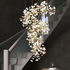 an elegant chandelier with white flowers hanging from the ceiling