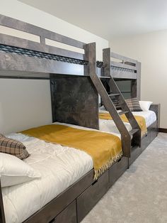 bunk beds with stairs in a room with carpeted flooring and walls painted white