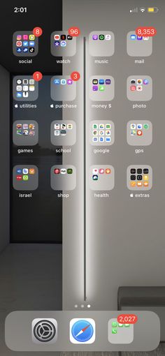 an iphone screen with several different icons on the wall and behind it is a silver refrigerator