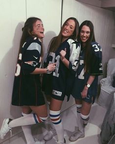 three girls are standing in the locker room