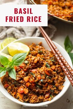 basil fried rice in a white bowl with chopsticks and lime on the side