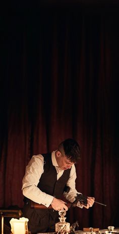 a man standing in front of a table with candles