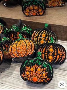 painted pumpkins are sitting on display for sale