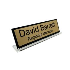 a black and gold sign that says david barrelt regional manager on it's side