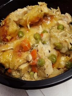 a black bowl filled with food on top of a table