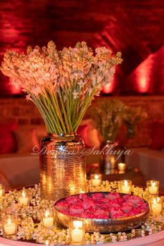 flowers and candles are arranged on a table