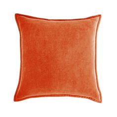 an orange velvet pillow on a white background